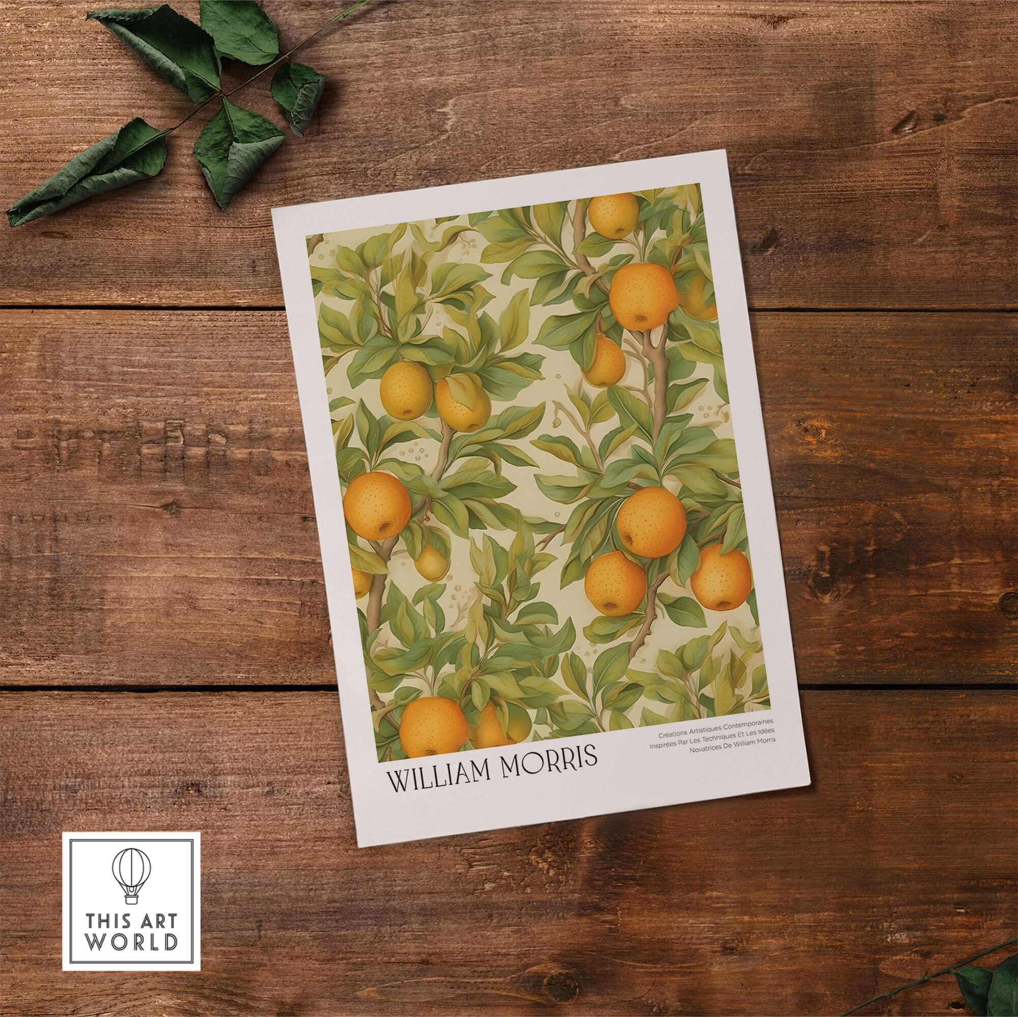 William Morris Prints - Orange Grove Fruit Tree Art Print - Botanical Poster displayed on wooden table with leafy background.