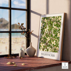 William Morris Prints - White Blossom Branch Art Print - Exhibition Poster displayed in a bright room by a window.