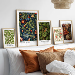 William Morris William Morris Fruit and Floral Vine Art Print - Dark Botanical Poster displayed on a couch.