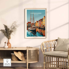 Copenhagen travel poster print featuring vibrant waterfront scene, stylishly displayed in modern home decor setting.
