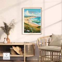 Cornwall art print displayed in a chic living room, showcasing beach scenery and lush greenery.