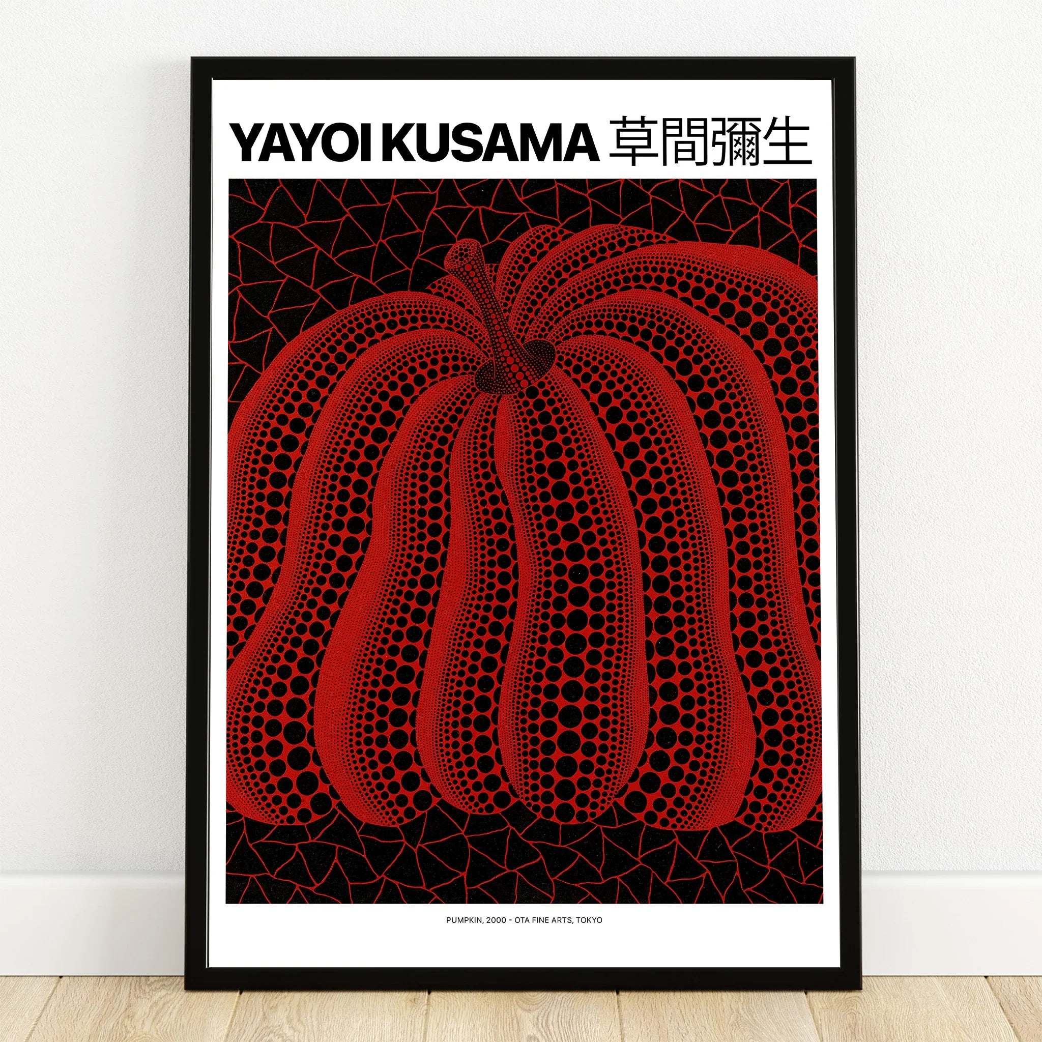 Framed wall art print of a red pumpkin with black dots on a geometric background