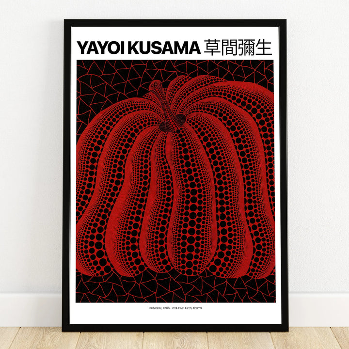 Framed wall art print of a red pumpkin with black dots on a geometric background