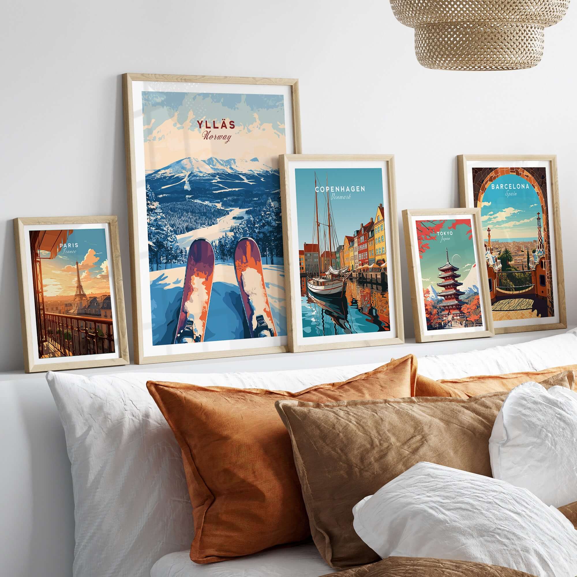 Ylläs Norway ski art print with vibrant winter landscape, displayed alongside travel prints on a cozy bed.