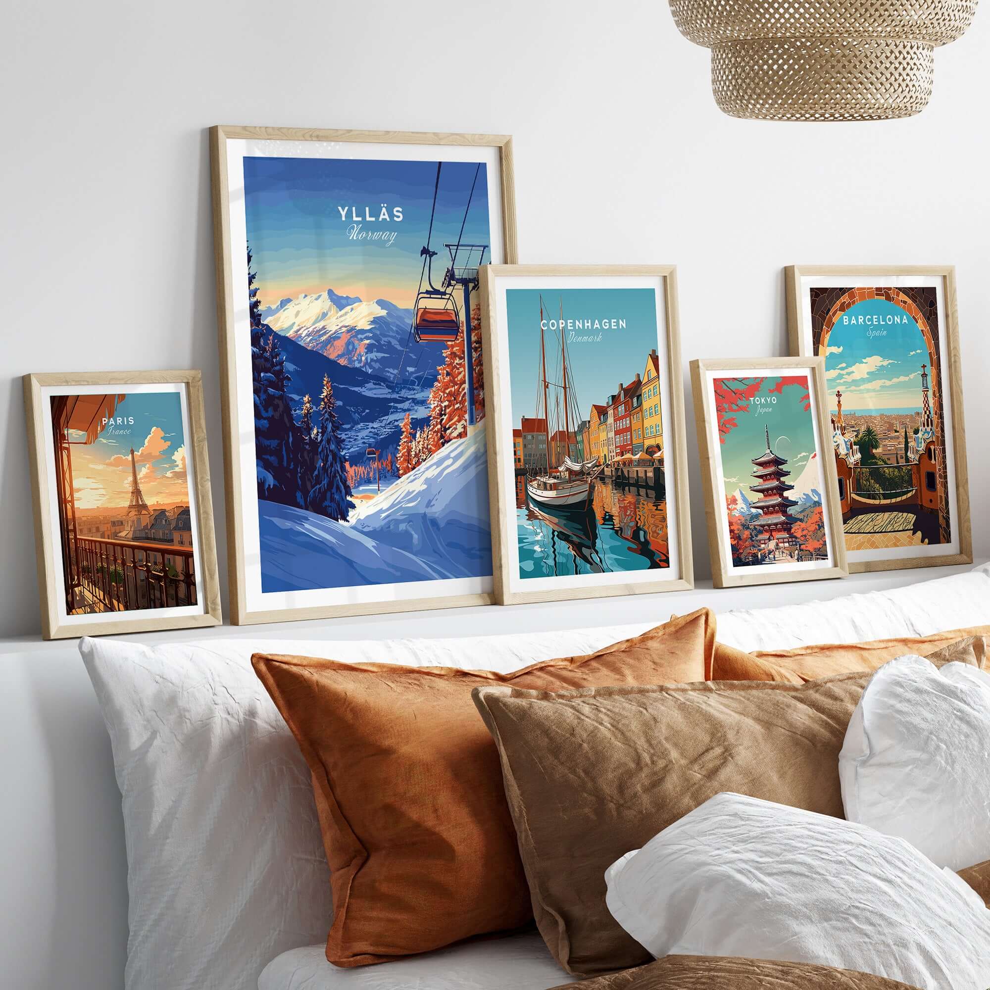 Ylläs ski lift poster and travel art displayed in stylish frames on a cozy sofa setting.