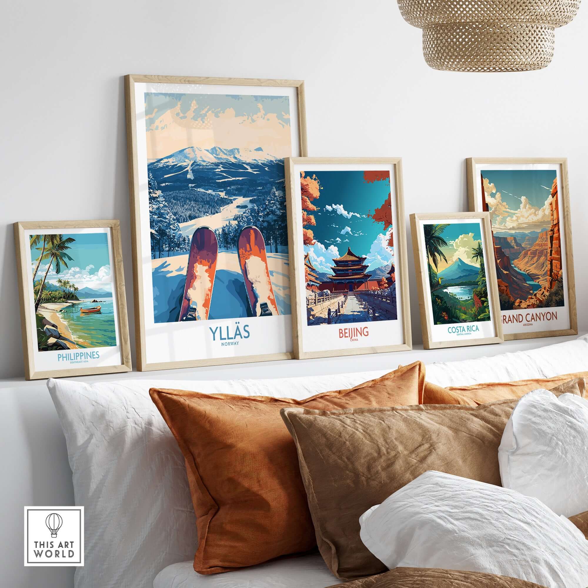Gallery of travel posters including Ylläs winter, Beijing, Costa Rica, and Grand Canyon, displayed on a modern sofa.