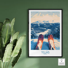Ylläs winter poster showcasing a skiing view from the slopes, featuring snow-covered mountains and skis pointed down.