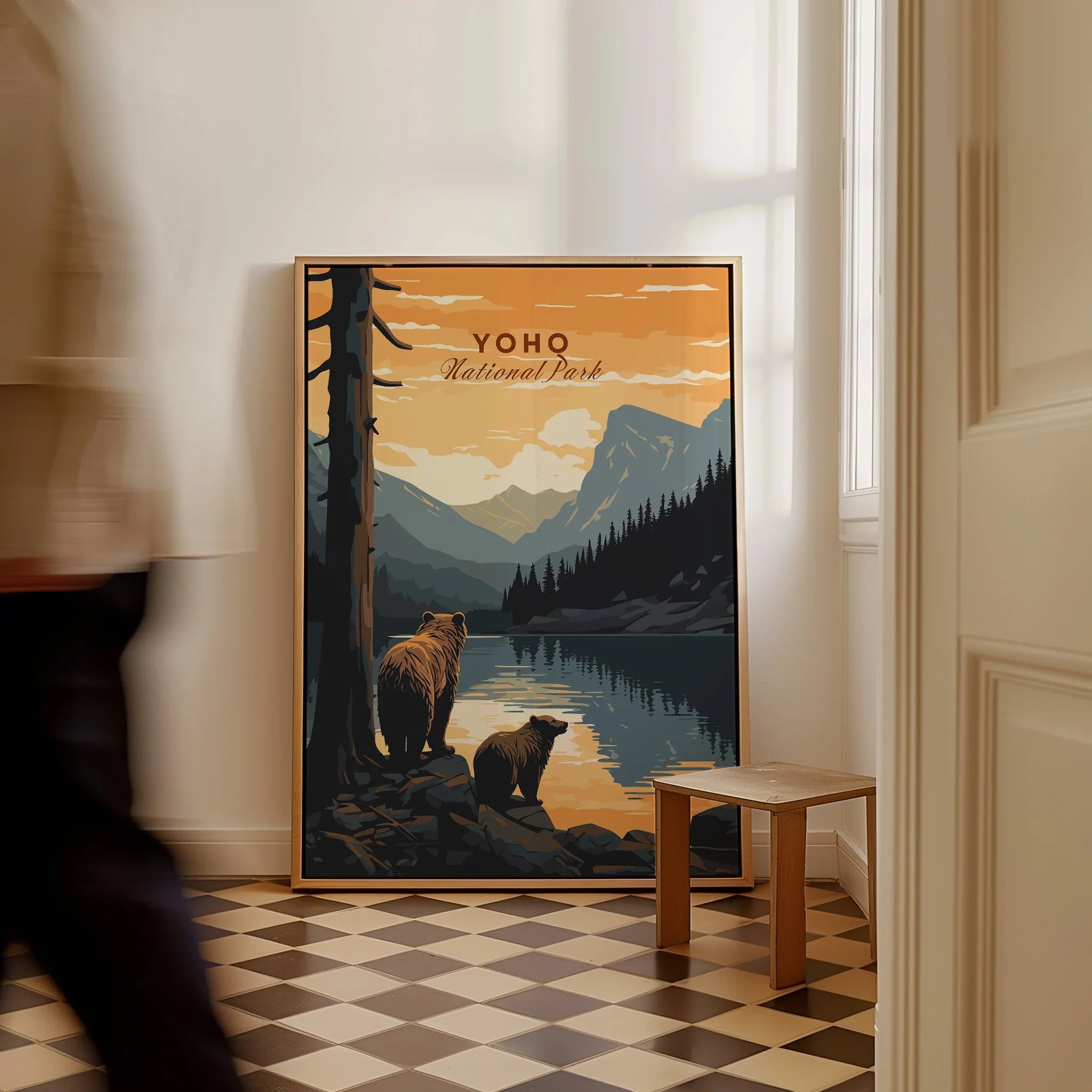 Framed Yoho National Park travel poster with bears by a lake, leaning on floor indoors