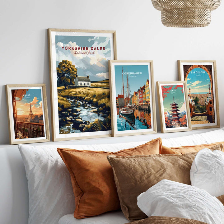 Framed Yorkshire Dales National Park poster alongside other city posters on a cozy sofa, showcasing travel art decor.