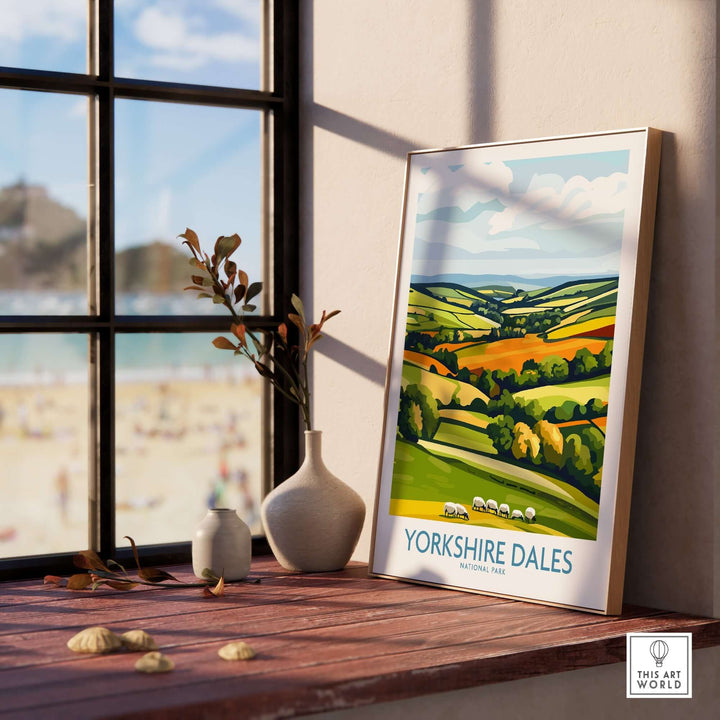 Yorkshire Dales National Park wall art print displayed on a windowsill, showcasing vibrant green hills and iconic sheep.