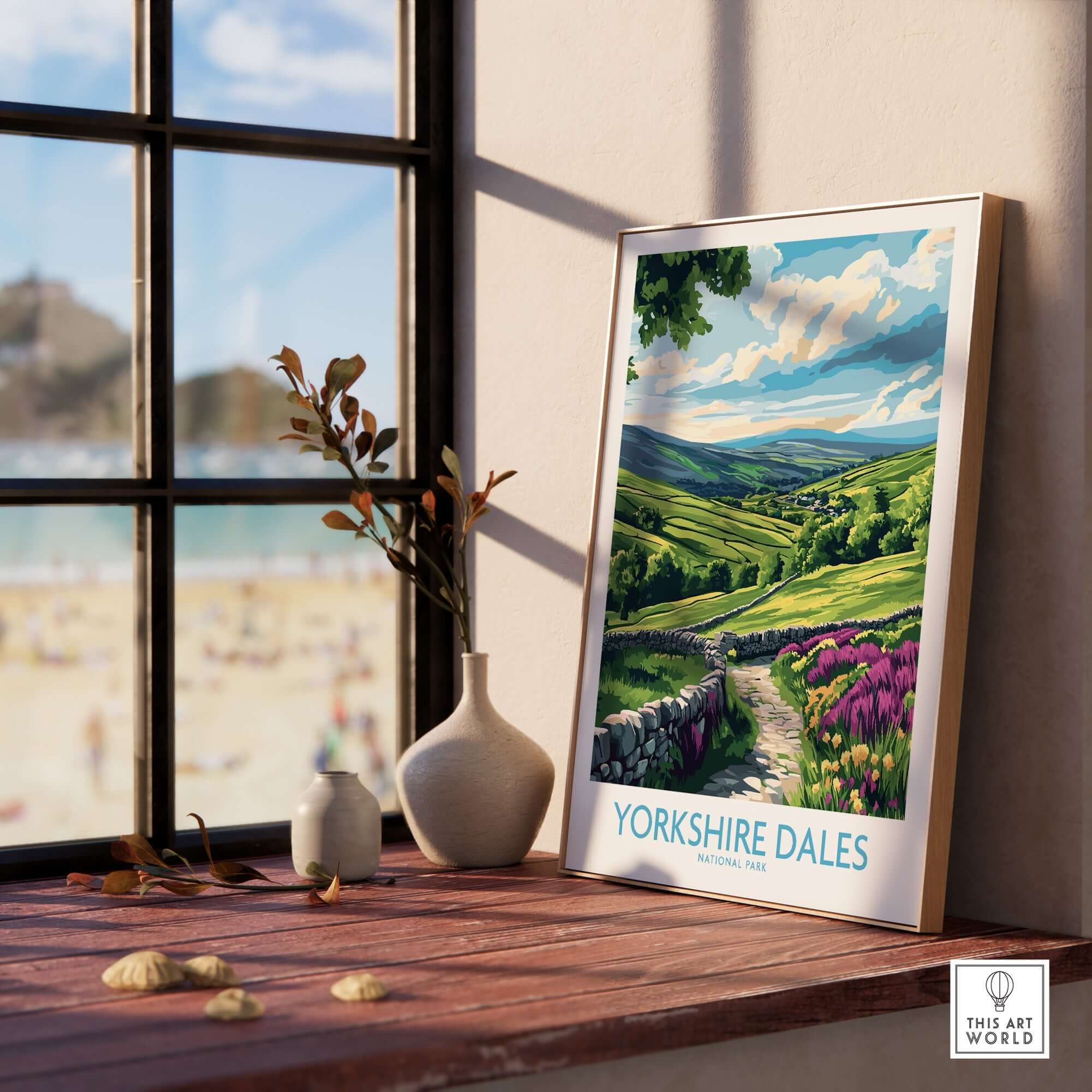 Yorkshire Dales National Park Wall Art Print displayed on a wooden table near a window with a scenic landscape.
