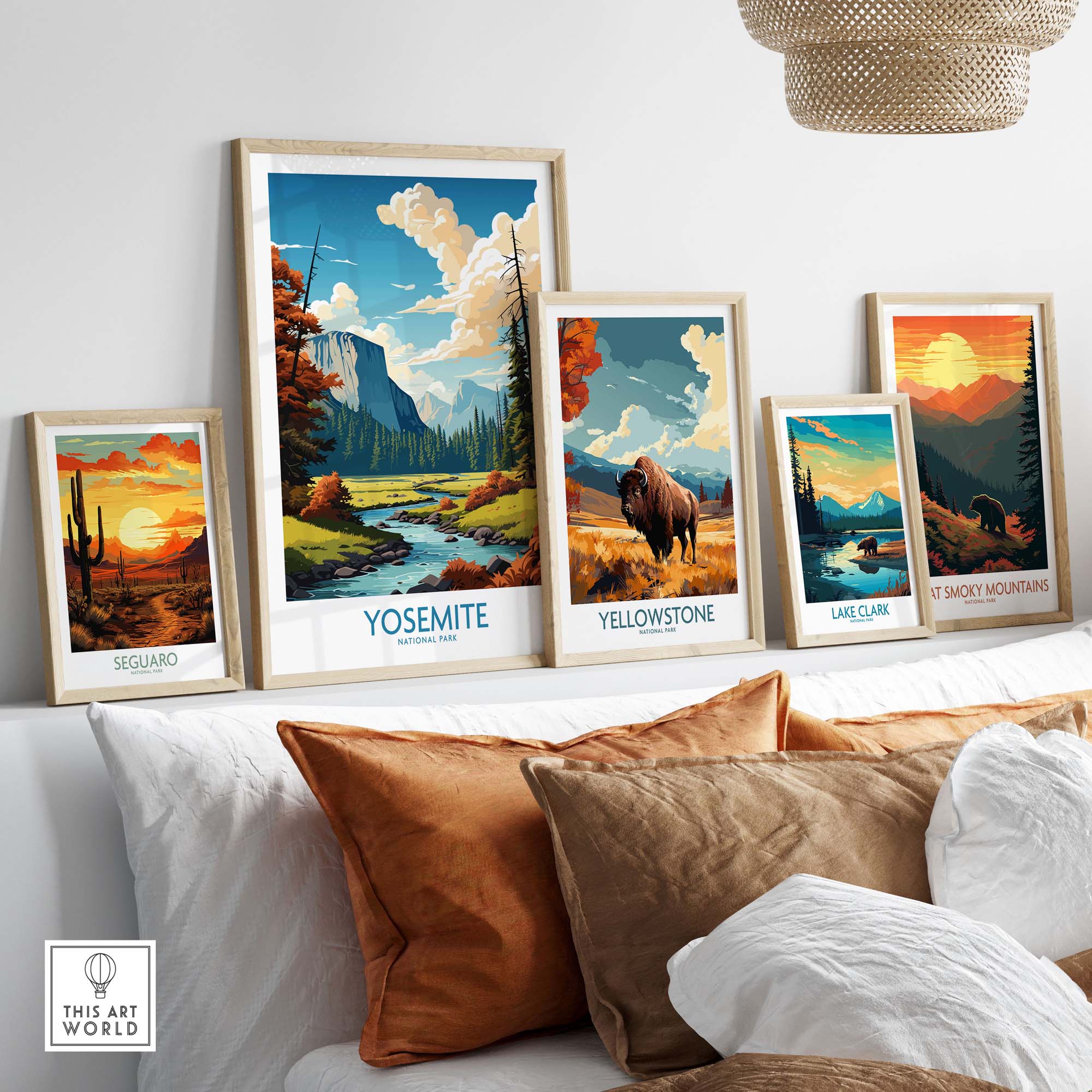 Vibrant framed art prints of Yosemite, Yellowstone, and Great Smoky Mountains displayed in a stylish living room setting.