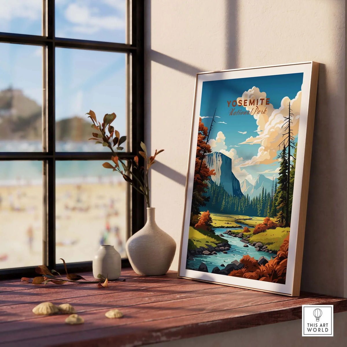 Framed Yosemite National Park poster on a wooden table by a window, showcasing stunning landscape art.