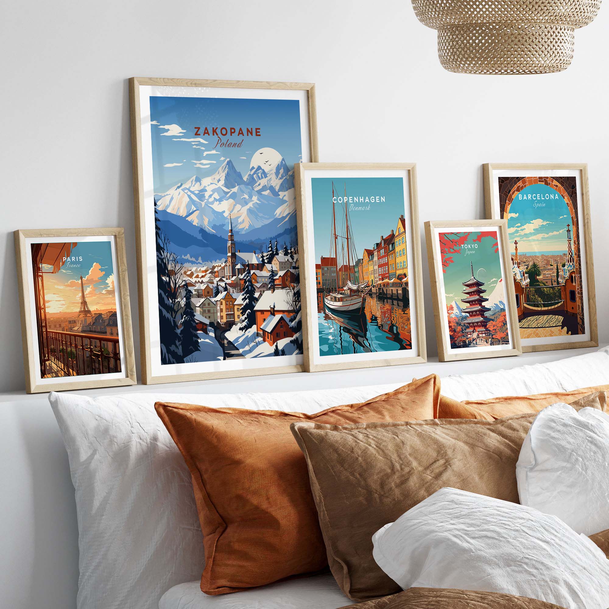 Zakopane Print and travel posters arranged on a stylish bed, enhancing home decor with vibrant colors and cultural themes.