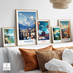 Collection of travel posters featuring Zakopane, Beijing, Costa Rica, and the Grand Canyon displayed in a stylish living room.