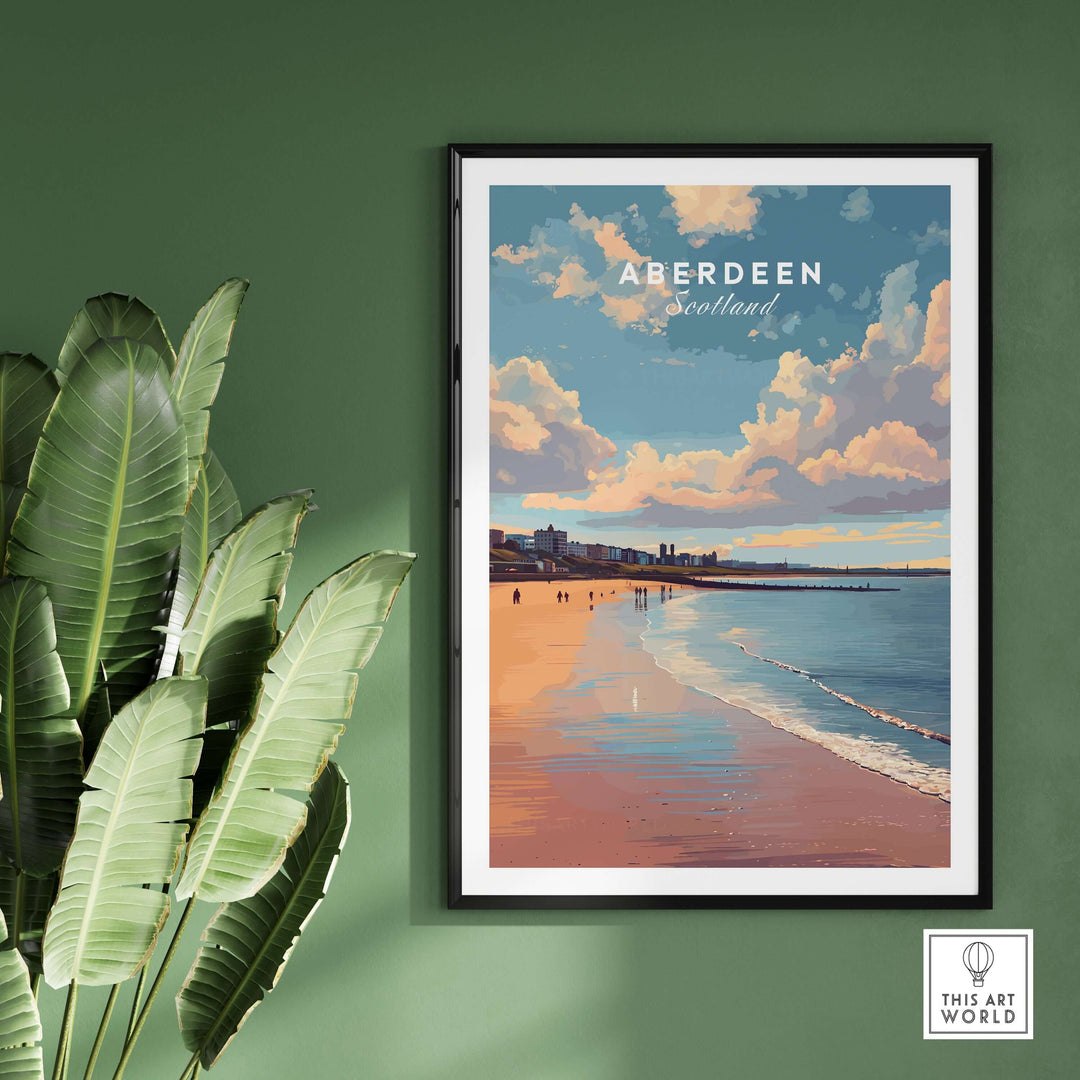 Aberdeen Beach Sunset Seascape Print | Colourful Coastal Wall Decor in a stylish frame on a green wall with tropical leaves.