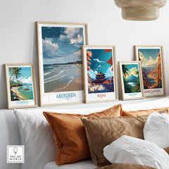 Aberdeen Scotland Bright Beach Scene Art Print | Coastal Poster displayed among other travel art prints on a stylish sofa.