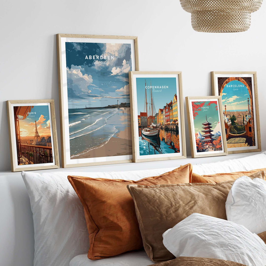Aberdeen Seaview Beach Shoreline Print | Modern Scottish Travel Decor displayed among other travel prints on a stylish sofa.
