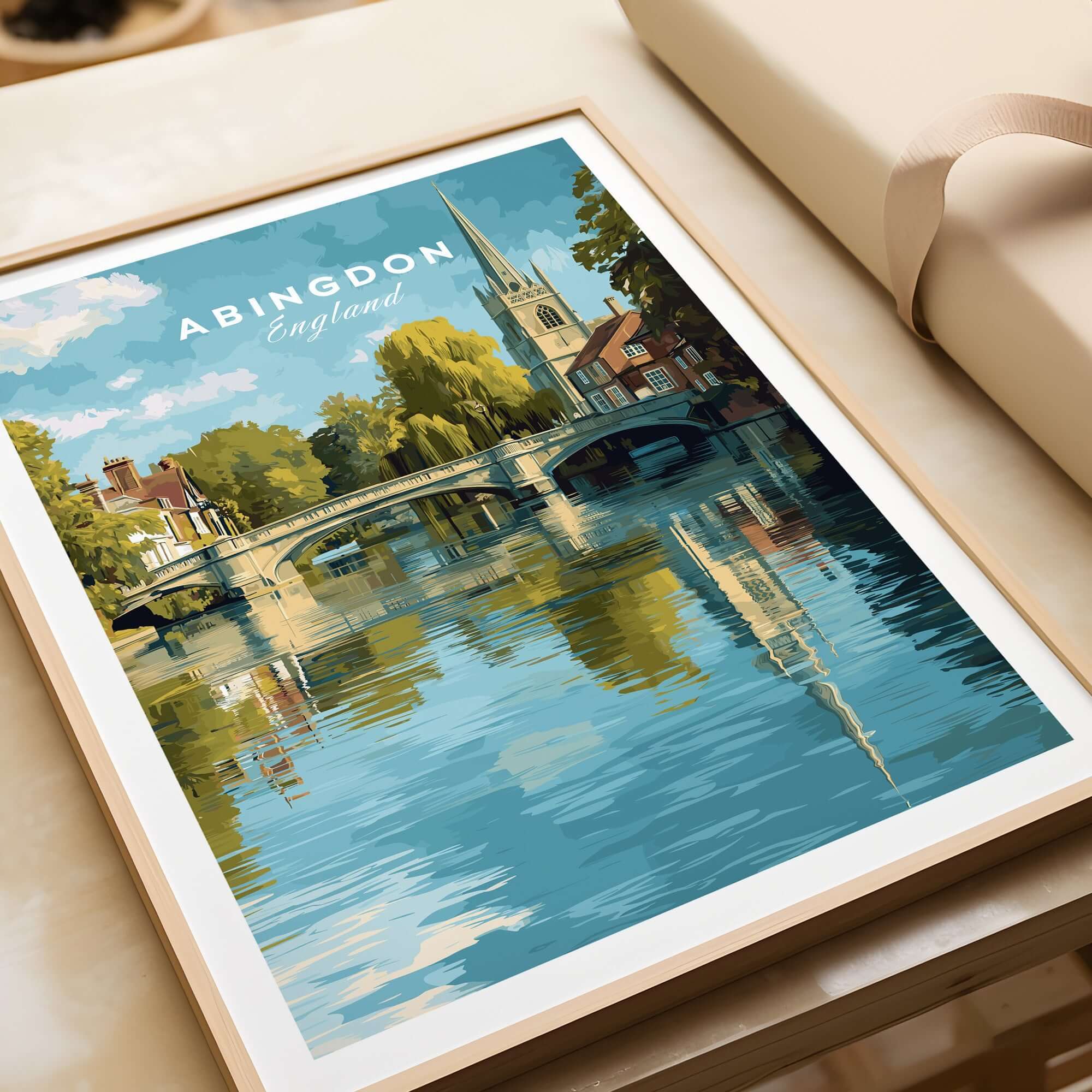 Abingdon England Riverside Print - Historic Town Wall Art Poster displayed on a table with reflections in water.