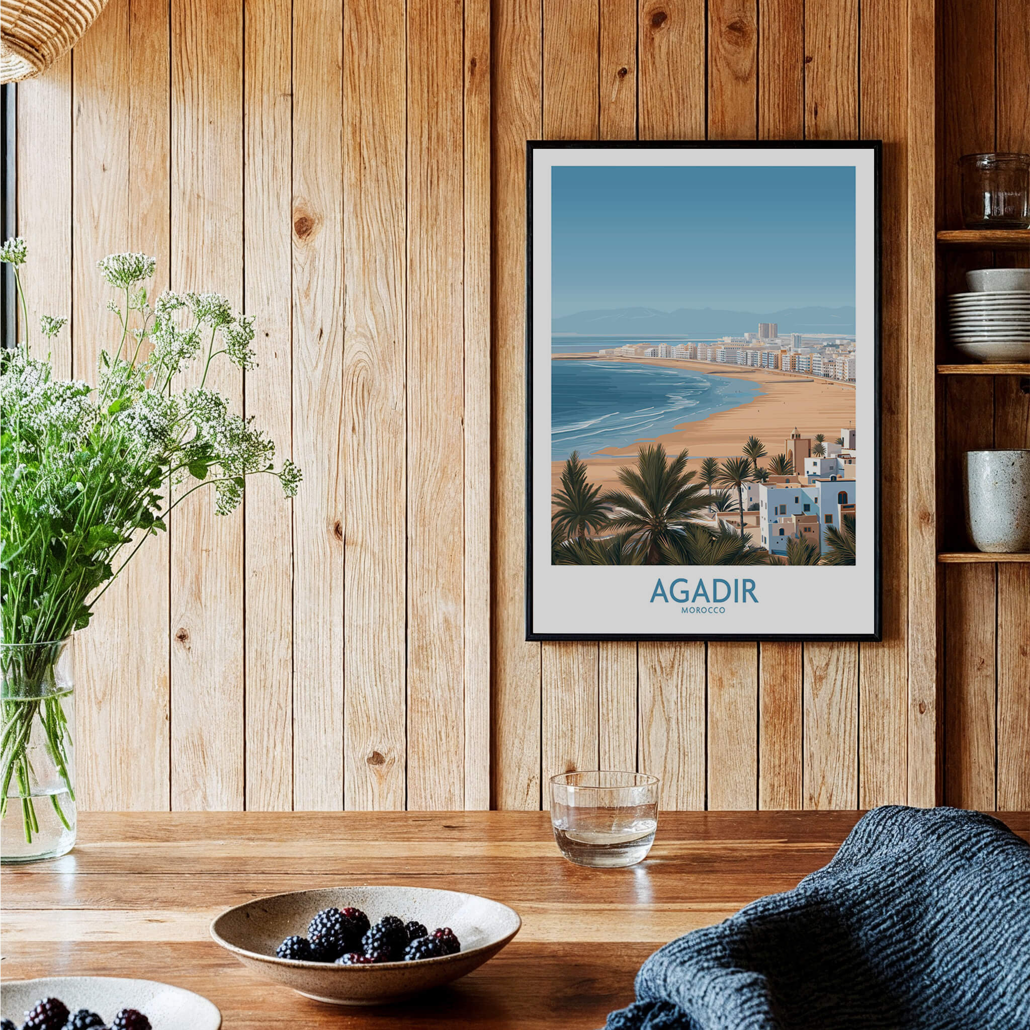 Agadir Morocco Print – Panoramic Beach and Palm Tree Wall Decor in a rustic wooden setting with plants.