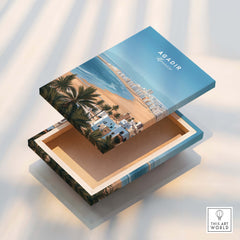 Agadir Morocco Poster – Travel Print featuring a beach scene box design with homes and palm trees.