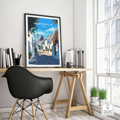 Alberobello Travel Print showcasing a charming street scene in a stylish home office setting.