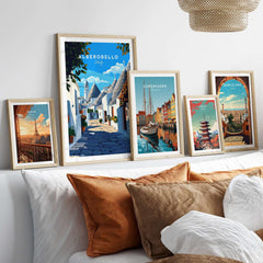Alberobello Travel Print framed among other travel posters on a stylish wall, showcasing Italian village charm.