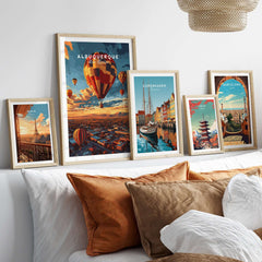 Albuquerque Print displayed among other framed travel prints on a stylish sofa with cushions.
