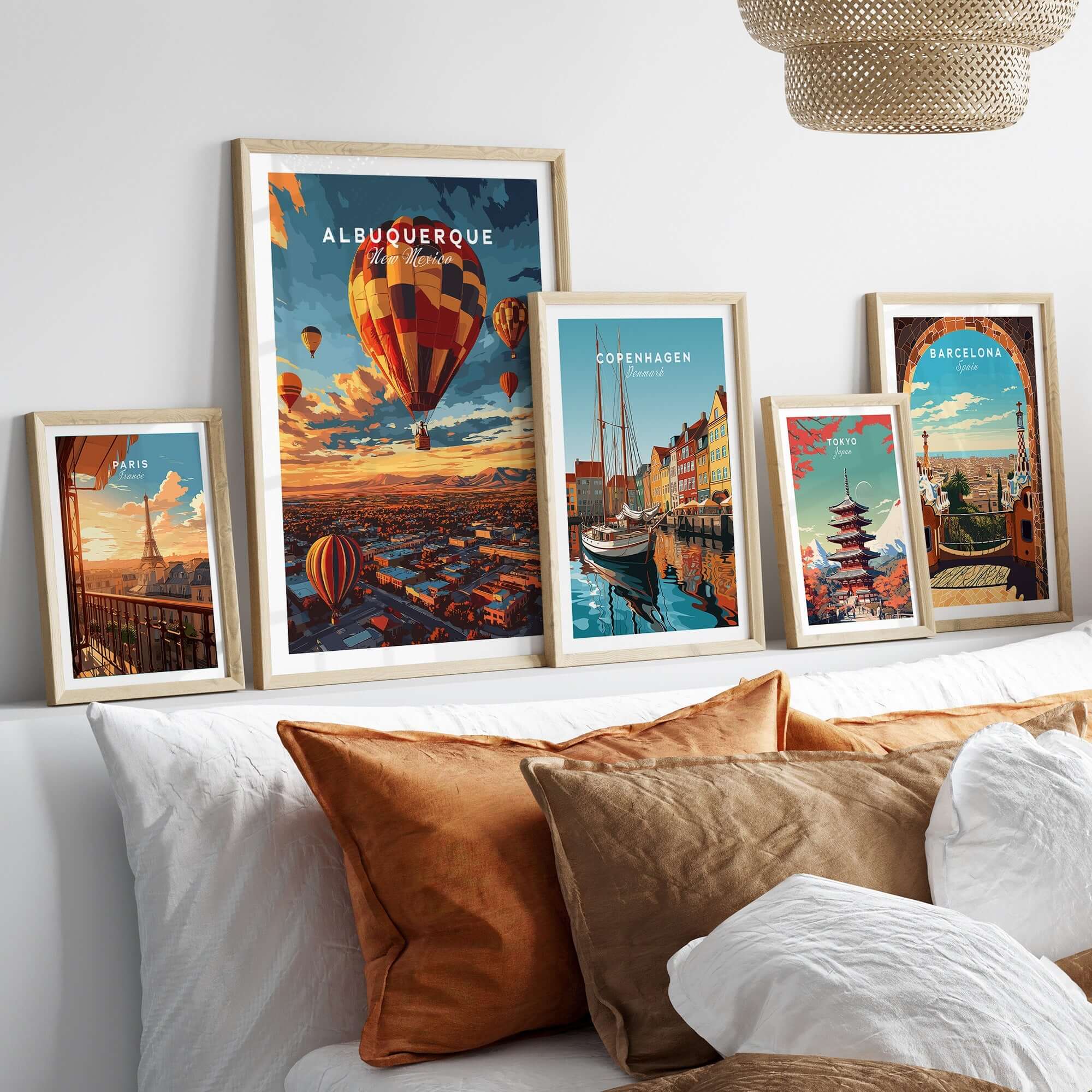 Albuquerque Print displayed among other framed travel prints on a stylish sofa with cushions.