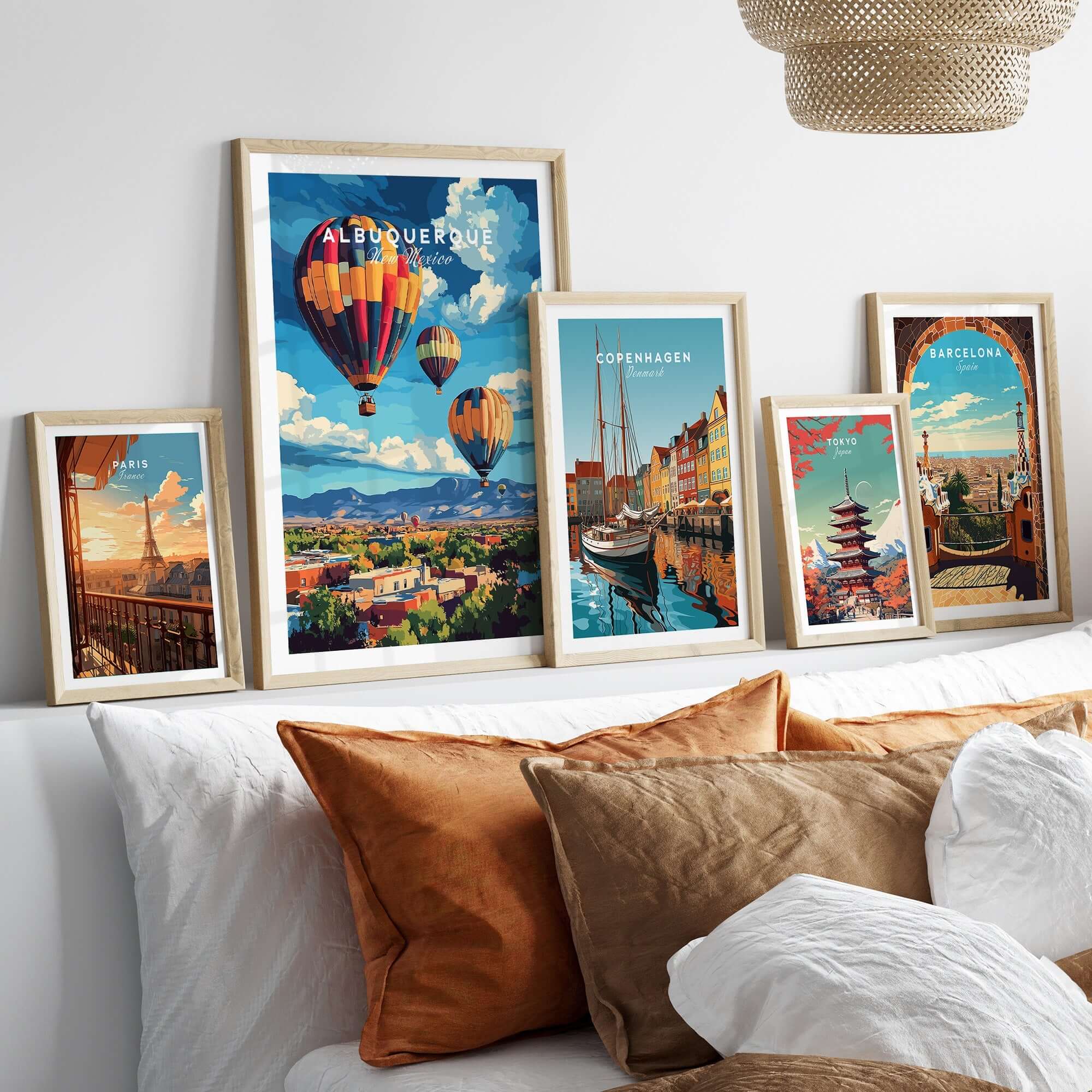 Albuquerque Print New Mexico among framed travel posters on a stylish bed.