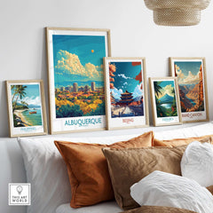 Albuquerque Travel Poster displayed among other art prints on a cozy couch, showcasing vibrant travel destinations.