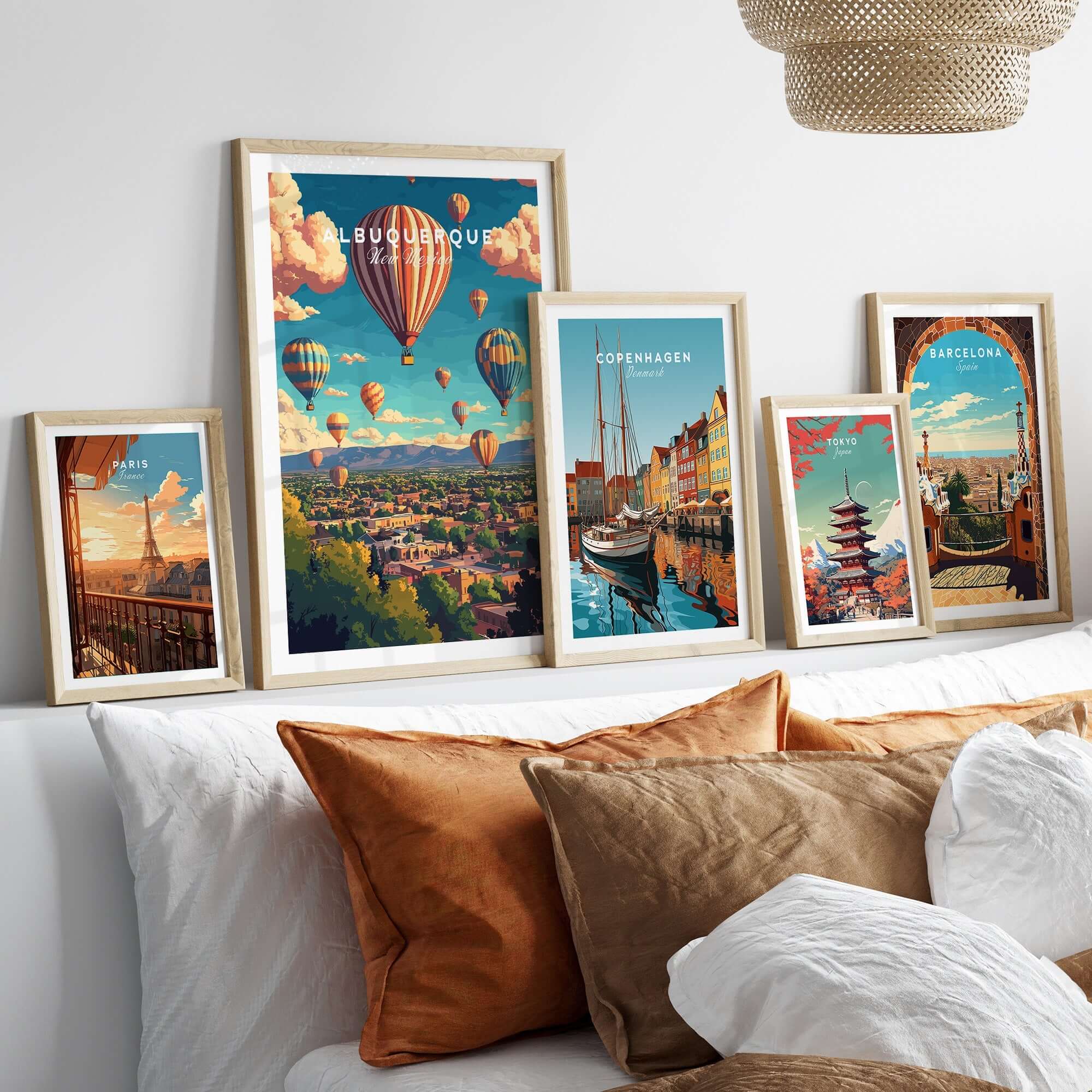 Albuquerque Wall Art Poster among framed cityscape posters on a stylish bed with decorative pillows.