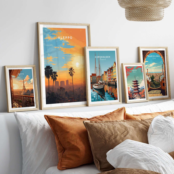 Aleppo City print featuring a vibrant sunset alongside travel-themed artwork in stylish frames on a cozy couch.