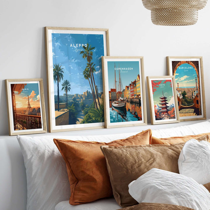 Aleppo skyline poster among framed city prints on a stylish couch, showcasing minimalist travel decor and serene scenes.