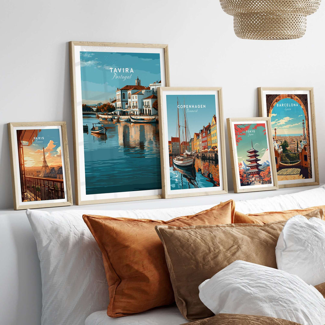 Tavira Portugal wall decor featuring framed cityscape posters on a stylish sofa with decorative cushions.