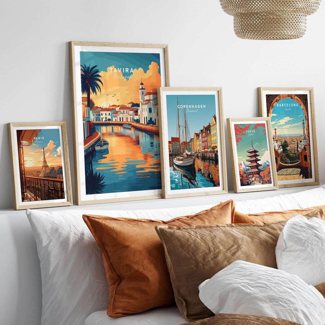 Galleria of framed travel posters including Tavira, Copenhagen, and Barcelona on a stylish interior wall.