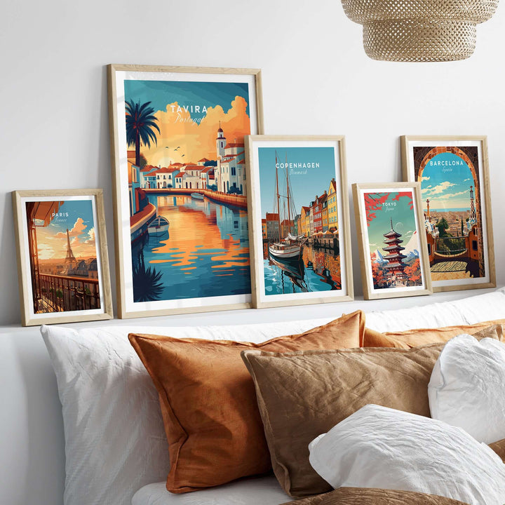 Galleria of framed travel posters including Tavira, Copenhagen, and Barcelona on a stylish interior wall.