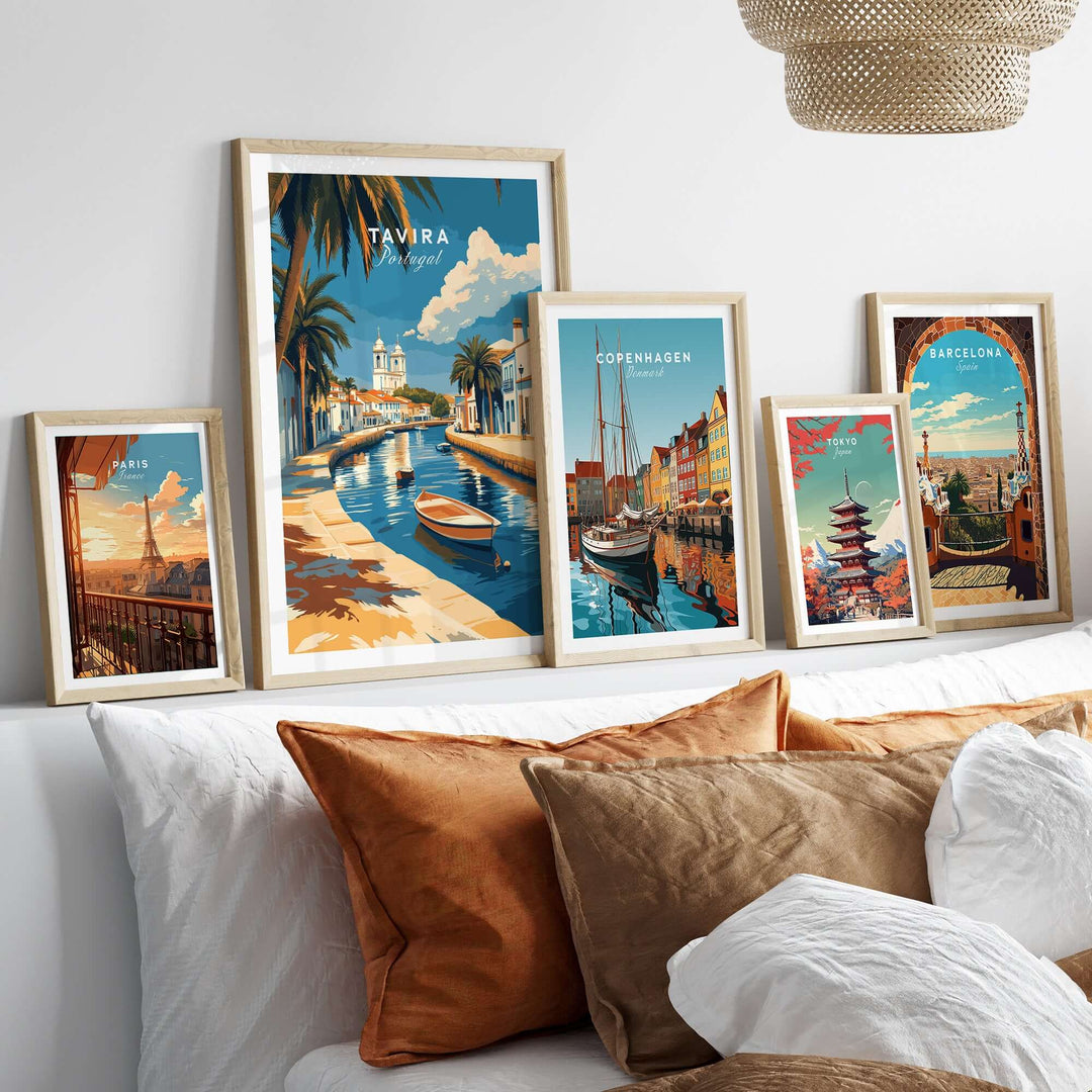 Algarve Tavira print and other city posters displayed on a wall above a cozy sofa.