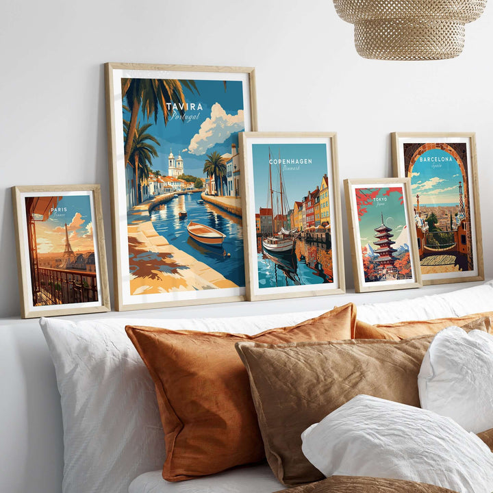Algarve Tavira print and other city posters displayed on a wall above a cozy sofa.