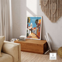 Algarve Tavira Wall Decor, Portugal Poster, Orange Flowers and White Walls Print displayed in a cozy living room setting.