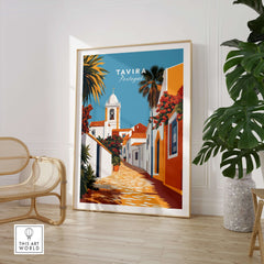 Algarve Tavira Wall Decor, Portugal Poster, Orange Flowers and White Walls Print displayed in a modern living room.