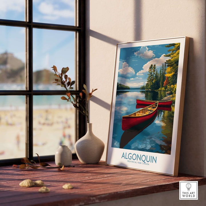 Algonquin Provincial Park Red Canoes Print | Canada Forest Lake Poster displayed on a wooden table near a window.