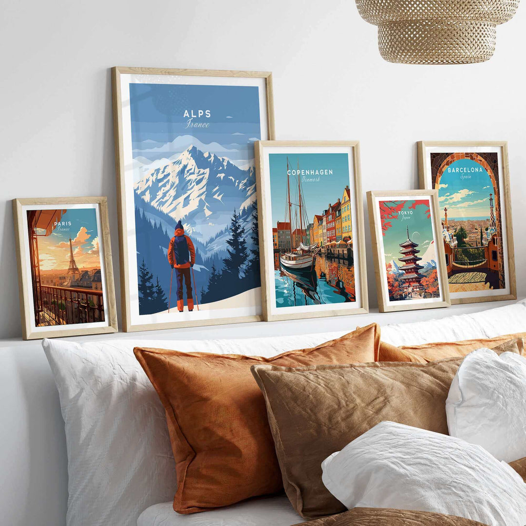 Framed Alps travel poster in a cozy living room setting with other city posters and decorative pillows.