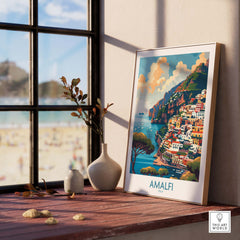 Amalfi Travel Poster - Stunning Italian Coastal View for Home Decor displayed on a windowsill with beach in background.