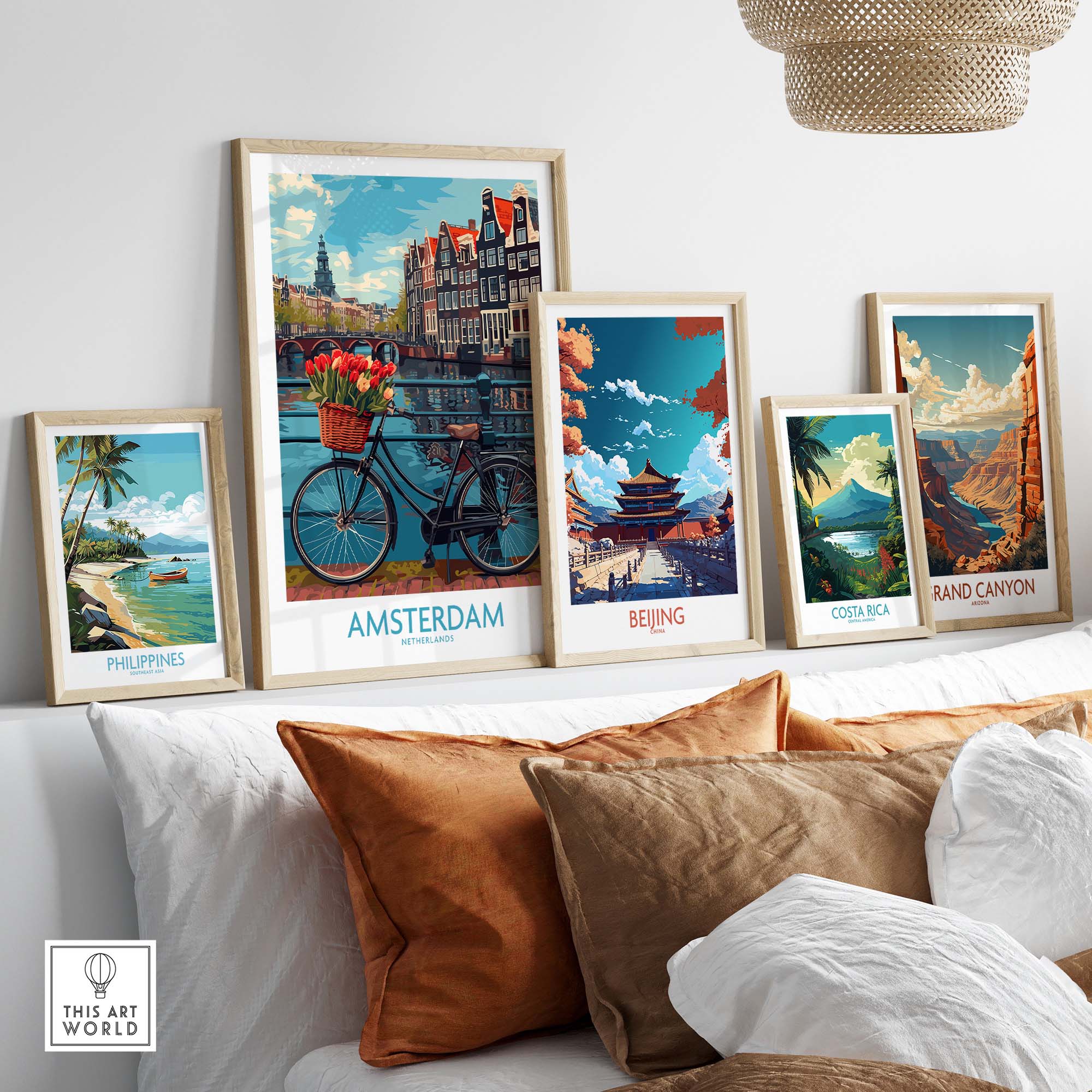Framed travel posters featuring Amsterdam, Beijing, Costa Rica, Grand Canyon, and the Philippines displayed on a shelf.