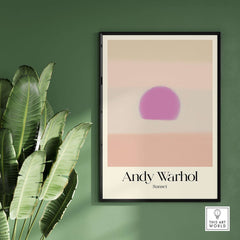 Andy Warhol Sunset Pastel Pink Purple Pop Art Print Subtle Abstract Poster Wall Art framed on a green wall with plants.