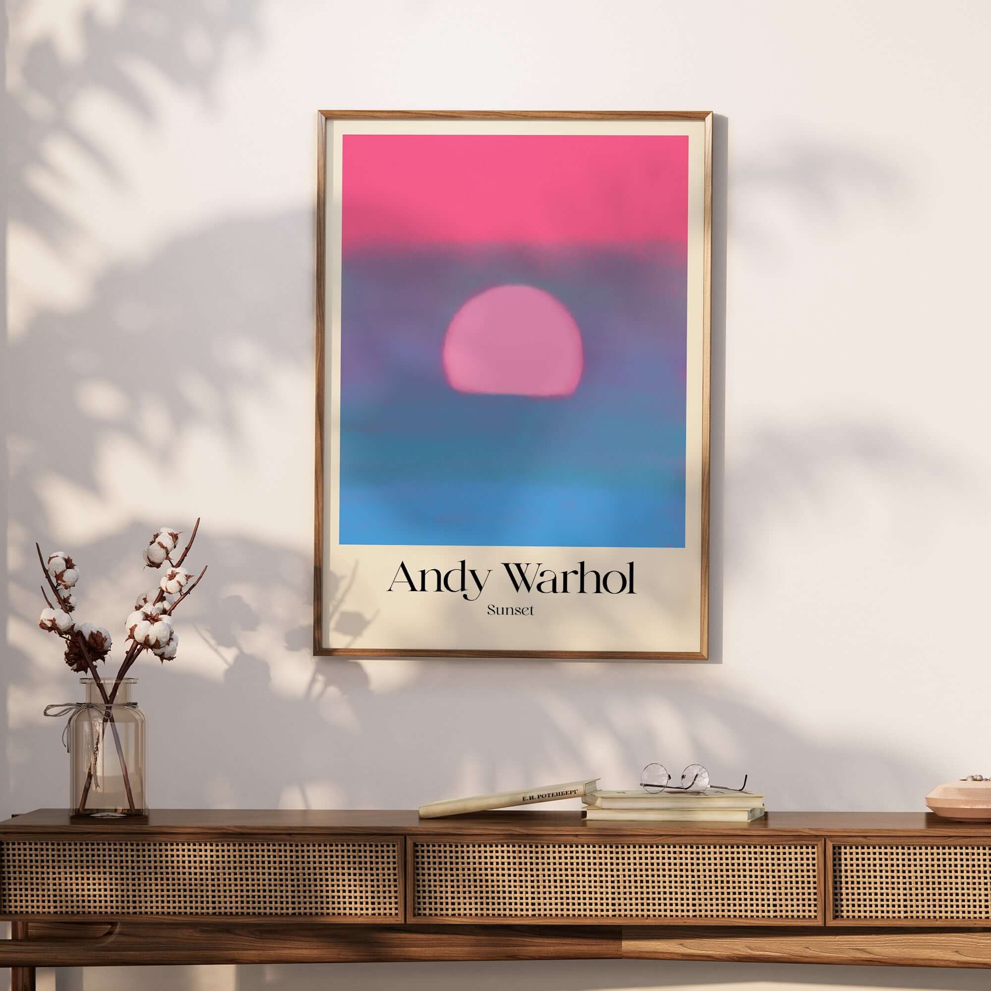Andy Warhol Sunset Pink Blue Pop Art Poster Abstract Screenprint Wall Art Print displayed on a stylish wooden table.