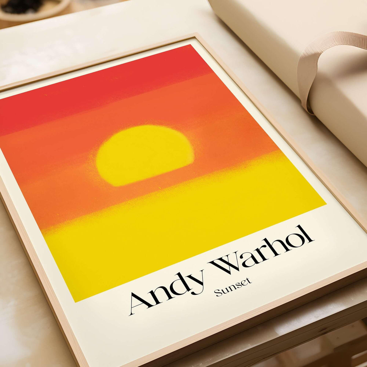 Andy Warhol Sunset Red Yellow Pop Art Abstract Print Modern Landscape Poster displayed on a table.