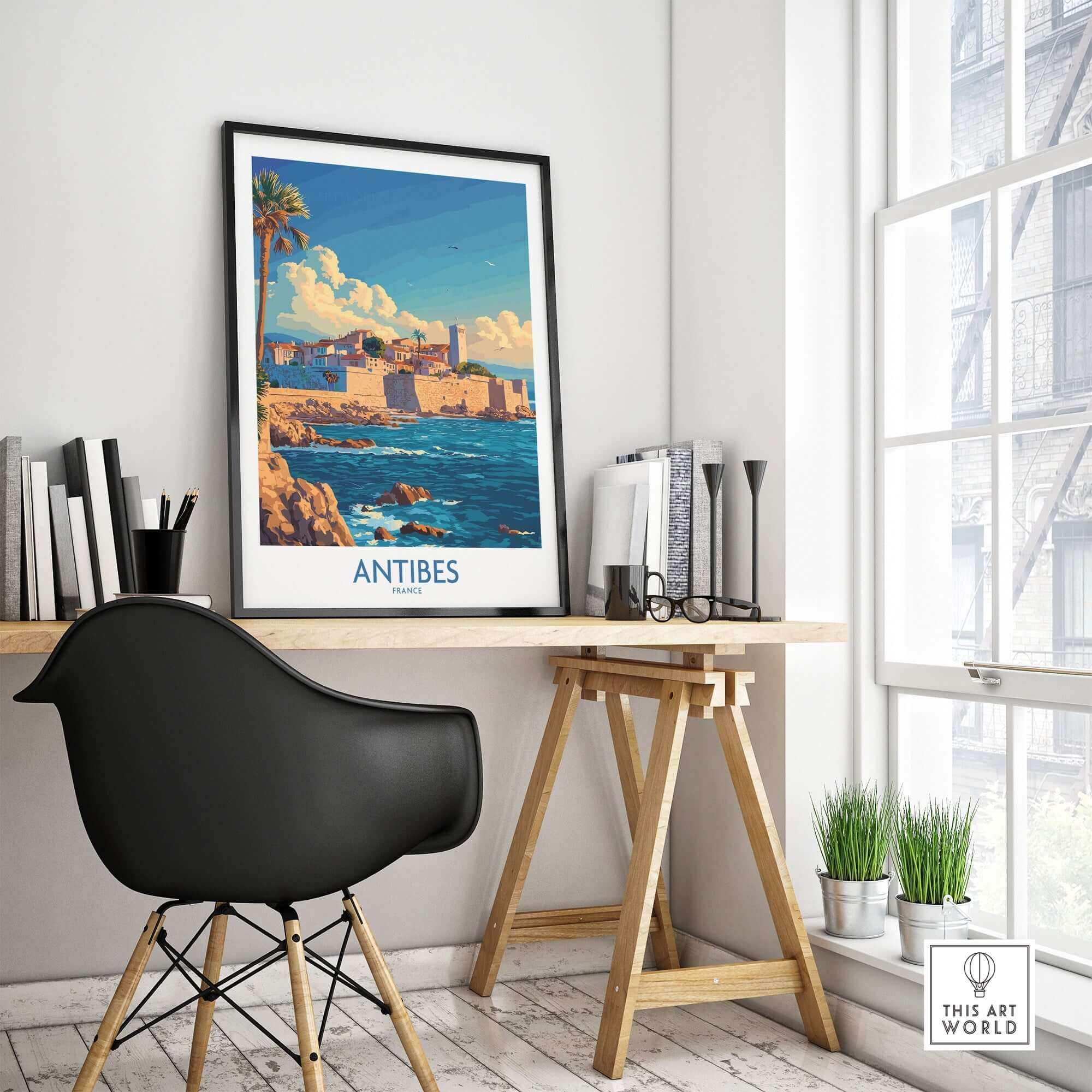 Antibes Art Print displayed in a stylish workspace, featuring a vibrant coastal scene of Antibes in France.