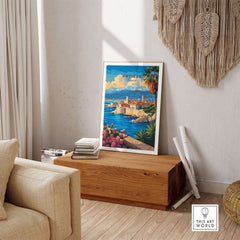 Antibes Travel Print displayed in a stylish living room, capturing the essence of the French Riviera.